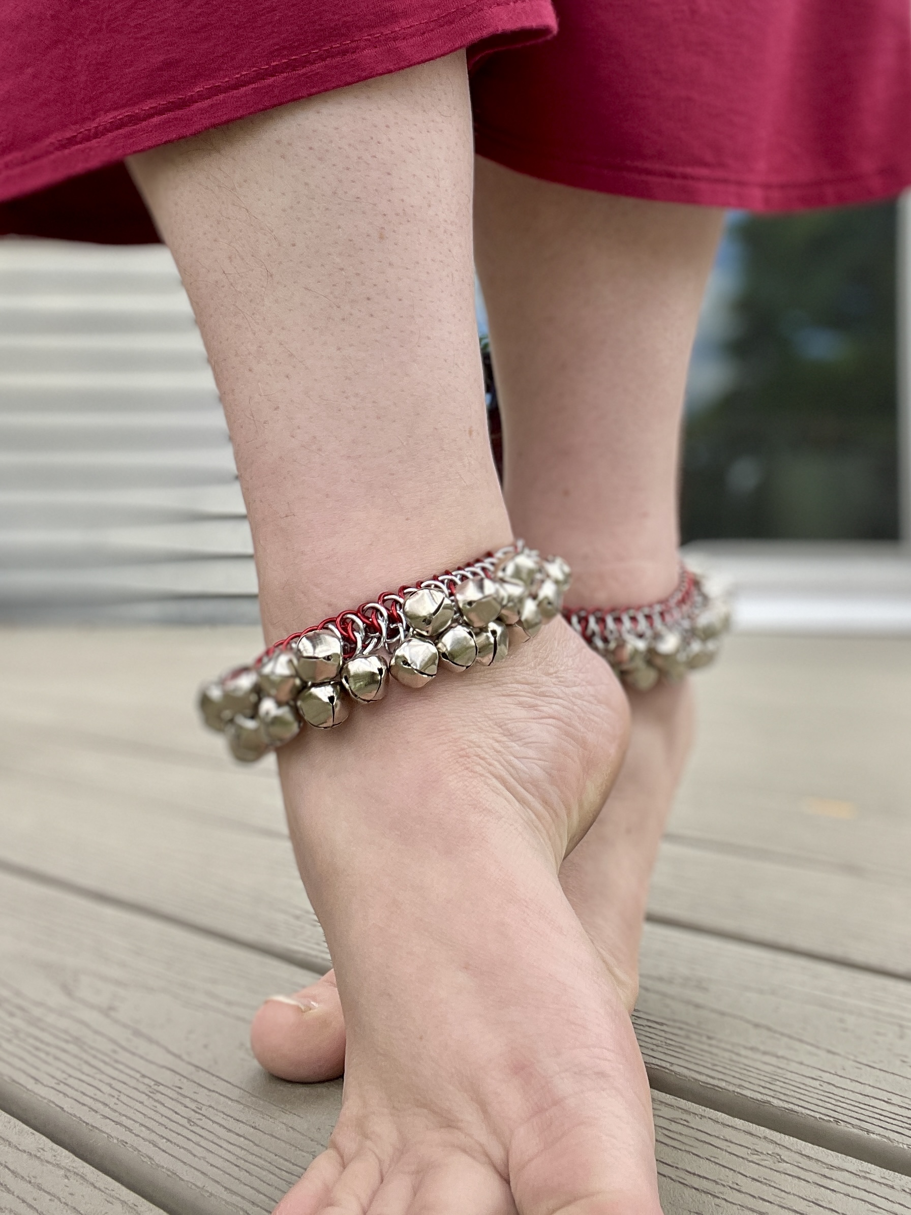 Chainmaille flower ornament displayed in a hand.