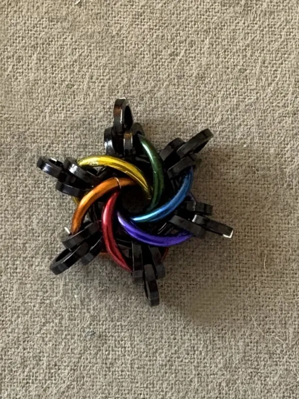 Chainmaille pendant in the shape of a star.